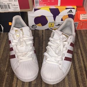 White and burgundy adidas superstars